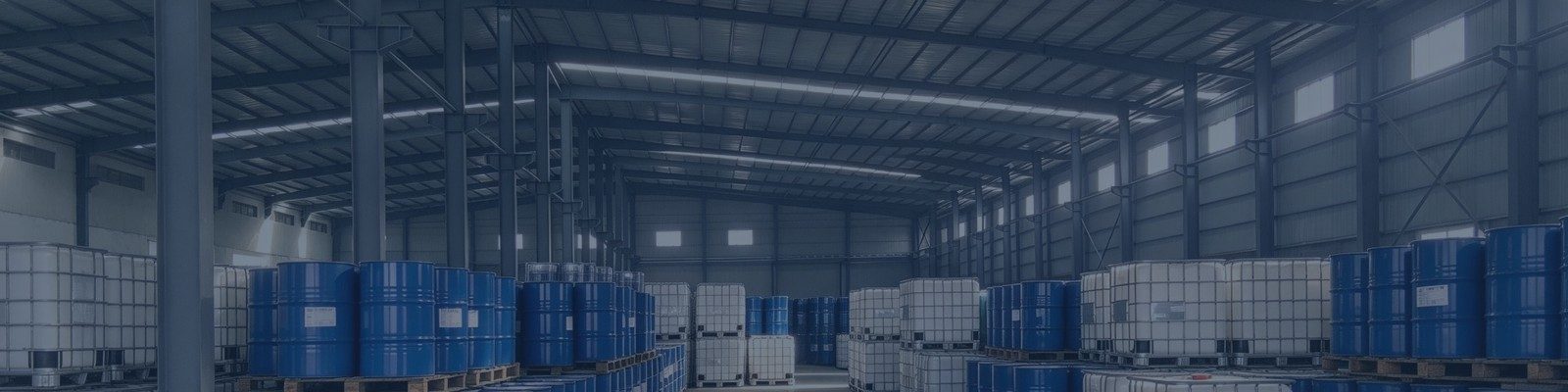 Clean warehouse with stacked silicone raw material drums and IBC tanks