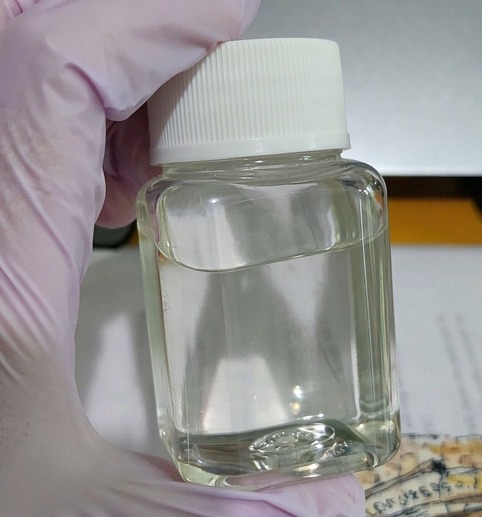 Damongwz silicone emulsifier reference sample in a clear bottle: colourless to light amber liquid.
